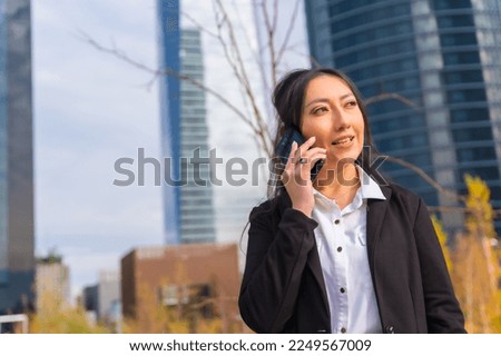 Latin businesswoman corporate portrait, business park, soft on phone