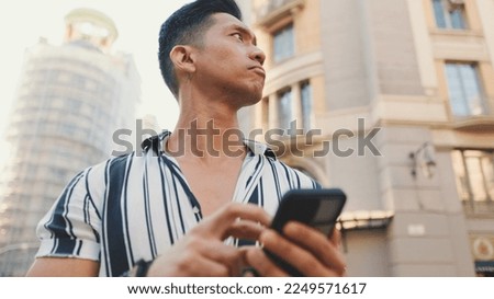 Close-up of young man tourist uses maps app on mobile phone