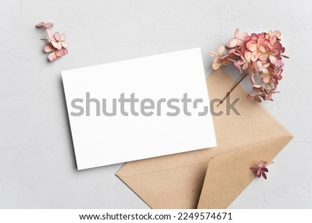 Blank wedding invitation or greeting card mockup with hydrangea flowers, flat lay, copy space