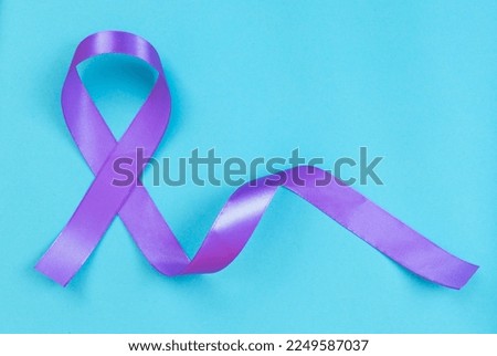 Purple ribbon on blue background ADD,ADHD,Alzheimer Disease ,Arnold Chiari Malformation,Childhood Hemiplegia stroke, Epilepsy, Chronic Acute Pain,Crohns Royalty-Free Stock Photo #2249587037