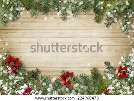 Christmas border with poinsettia on old wood background