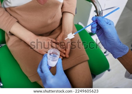 PAP test, cervical screening test. Gynecologist doctor taking smear for cytology from female patient in gynecological office, close-up Royalty-Free Stock Photo #2249605623