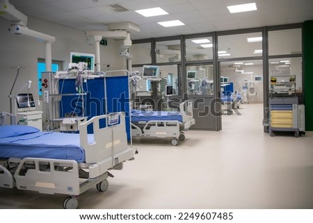 Modern technology in empty intensive care unit room with different equipment and devices, beds and pillows. Royalty-Free Stock Photo #2249607485