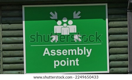 Green and white Assembly point sign 
