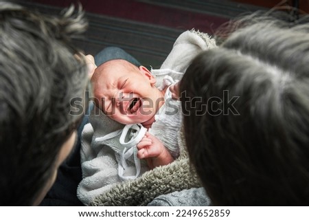 Newborn baby colic close up. Young parents and crying baby 1 month old. Royalty-Free Stock Photo #2249652859