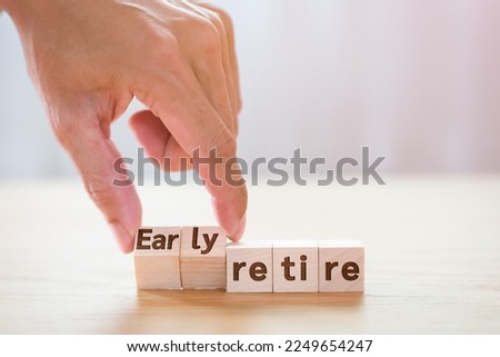 Hand man tuning wooden cube with wording early retire, Monney saving concept