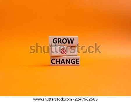 Grow and Change symbol. Concept word Grow and Change on wooden blocks. Beautiful orange background. Business and Grow and Change concept. Copy space