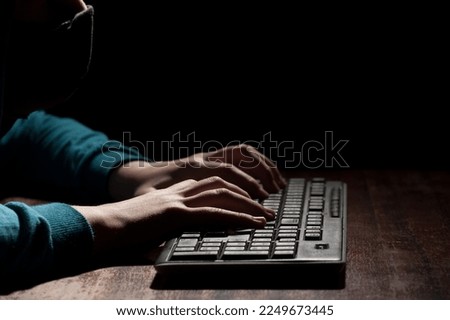 Unknown person hands using a keyboard sends message with intimidating and threatening to the interlocutor Royalty-Free Stock Photo #2249673445