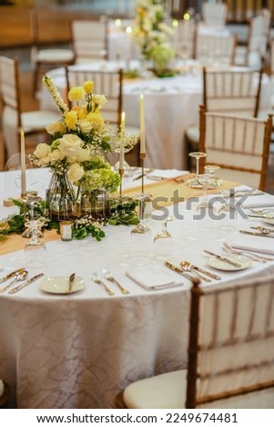 Elegant table setting decorated with lighted candles, tableware, flowers, accessories for a party, wedding reception, gala banquet or other holiday event. Royalty-Free Stock Photo #2249674481