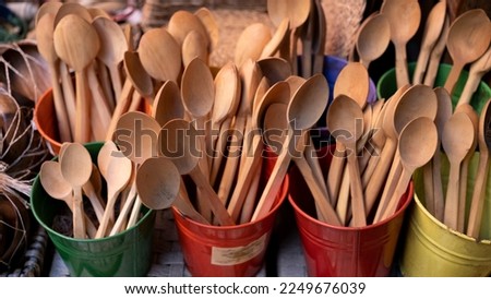 Spoons of different sizes made of wood, handmade kitchen utensils.