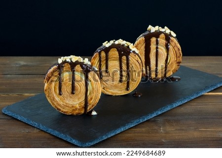 New York roll, round croissant filled and covered with chocolate.  Royalty-Free Stock Photo #2249684689