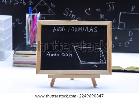 Blackboard with hand written geometry area formulas and geometric shapes and figures