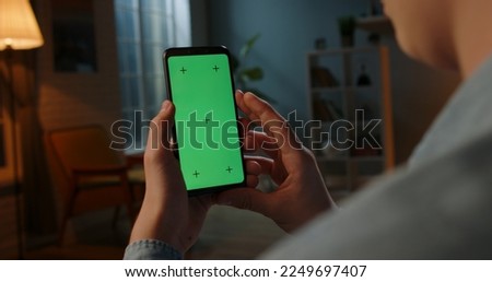 Close up shot of man holding a smartphone with chroma key mock up green screen - technology, connections, communications concept  Royalty-Free Stock Photo #2249697407