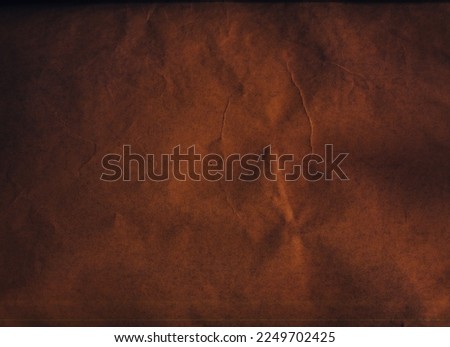 Old paper texture. Vintage background. Creased noise. Brown black color grain dust scratches on dark uneven rough grunge abstract free space.
