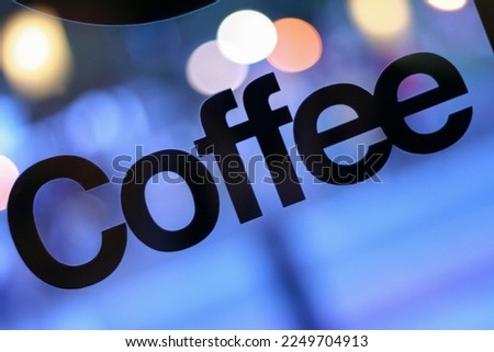 Coffee Sign in Window with Bokeh and Blue Hour Evening Background