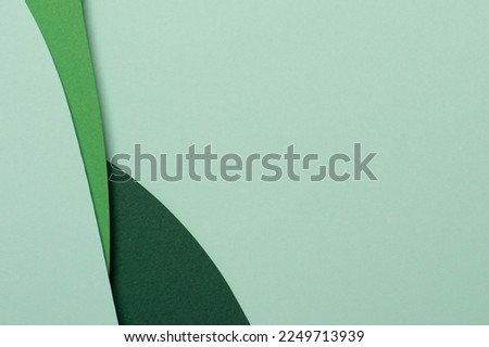 Abstract green color paper texture background. Minimal paper cut style composition with layers of geometric shapes and lines in green tone shades. Top view Royalty-Free Stock Photo #2249713939