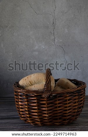 Several pieces of typical Majorcan bread, called "llonguet" in a wicker basket.