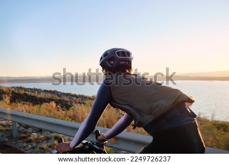 Fit male cyclist riding dirt trails on a gravel bike. A man riding a gravel bike on a gravel road in a scenic view with hills in Murcia region, Spain.
Sports motivation.Gravel road in mountains.