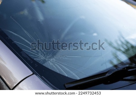 broken car windshield, chipped and damaged car glass, copy space Royalty-Free Stock Photo #2249732453