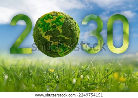 Numbers 2030 with green planet. A symbol of sustainable development and transition to renewable energy by 2030 year. Royalty-Free Stock Photo #2249754151