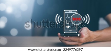 Man hold smartphone icon with Emergency app in home, call phone, Chat message icon, Emergency application from smartphone for elderly, technology concept.Old hand touch mobile phone and call for help.