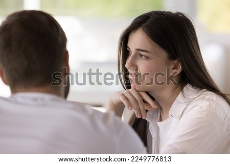 Pretty girl feeling boredom, doubt during dating. Bored young woman meeting with boyfriend in cafe, listening to man, sitting at table, touching chin, looking away, thinking, dreaming Royalty-Free Stock Photo #2249776813