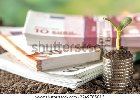 Money, US dollar bills background. Paper money is scattered on the table with silver coins. Photo for finance and economics concepts.