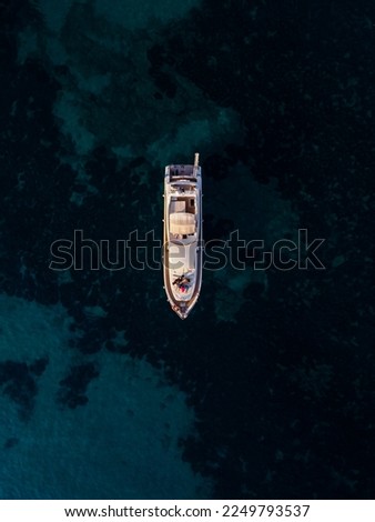 aerial drone view of a luxury yacht sailing on open water, showcasing the ultimate in luxury
