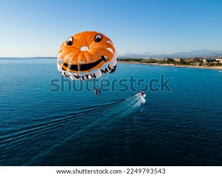 Parasailing in the clear blue sea at a luxury hotel resort, the ultimate vacation experience Royalty-Free Stock Photo #2249793543