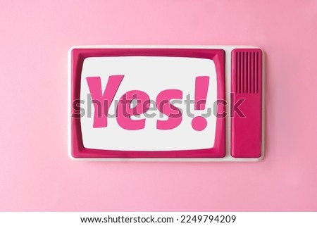 Magenta letters yes! on white background of a retro tv with magenta frame. Minimal romantic concept for Valentine or engagement banner or card. Flat lay. Love is in the air design
