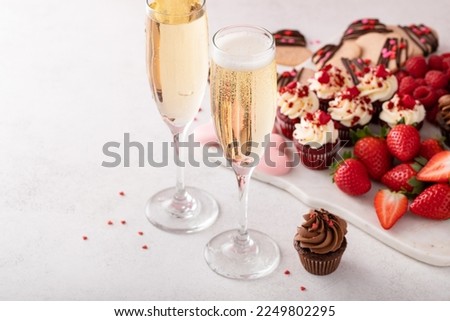Champagne or sparkling wine for two for Valentines day with dessert board Royalty-Free Stock Photo #2249802295