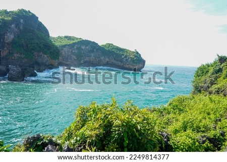 Stock photo of natural landscape view of beautiful tropical beach and sea on a sunny day in Indonesia