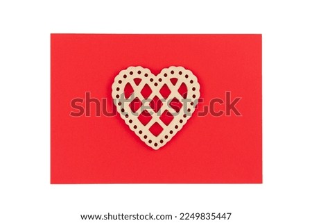 Minimalistic red Valentine's Day background with wooden decorative heart, flat lay.