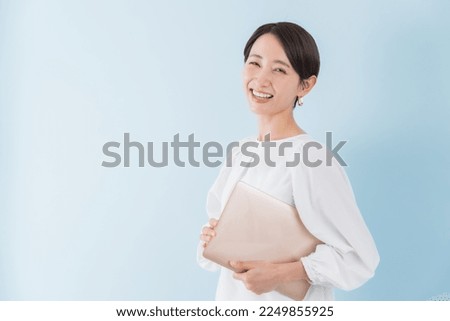 Pretty Japanese woman with a computer Royalty-Free Stock Photo #2249855925