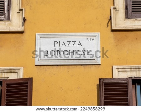 Roma, Italy. View of a Road name sign on a facade of a house. Piazza Borghese a very famous square in the city of Rome