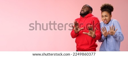 Studio shot pair african american friends woman man cringing disgust dislike feel awkward reluctant step back raise palms defensive refusing rejecting try stinky product, standing pink background. Royalty-Free Stock Photo #2249860377