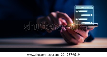 Businessman holding hologram Chat GPT virtual icon on smartphone intelligence Ai, Chat GPT Chat with AI Artificial Intelligence, Futuristic technology, robot in online system. Royalty-Free Stock Photo #2249879519