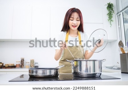 Image of young Asian woman in the kitchen