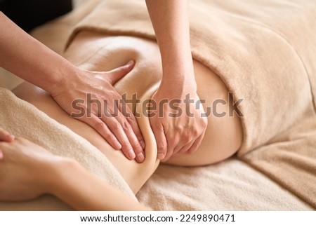 A woman receiving a belly massage at a beauty salon Royalty-Free Stock Photo #2249890471