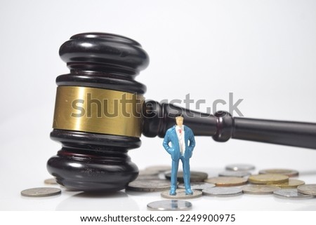 Selective focus image of miniature of people with gavel and money. Business,labor and law concepts. 