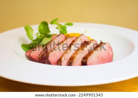 Duck magret cooked in the oven and cut into slices.