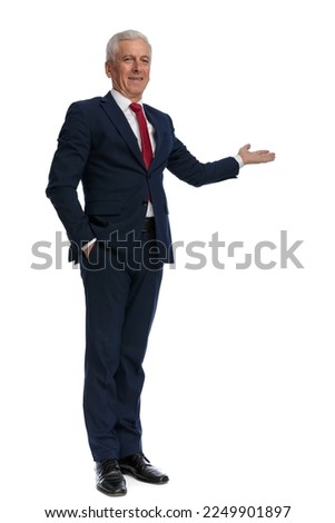 full body picture of an old businessman presenting something to the side, putting one hand in pocket