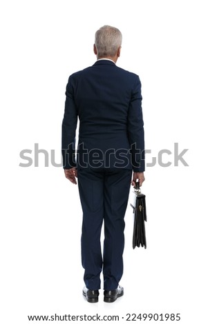 full body picture and the rear view of an old businessman standing with his back at the camera and holding a briefcase