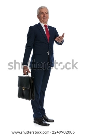 full body picture of an old businessman going to work with his briefcase then greeting with open arm