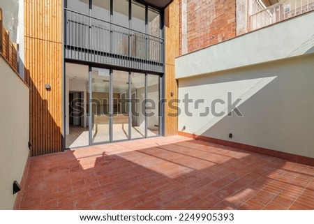 Sunny view of the patio of refurbished apartment in contemporary building. Outdoor exterior of narrow modern house in Barcelona, Spain