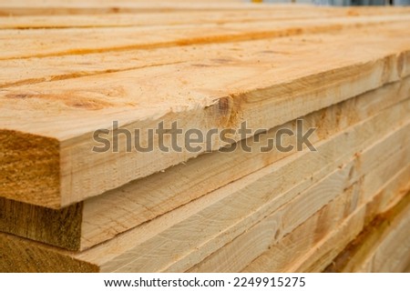 Stacked rough sawn timber planks ready for construction. Royalty-Free Stock Photo #2249915275