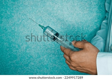 Doctor with a Syringe in his Hand Before Surgery