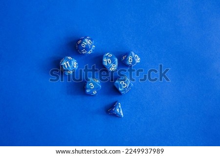 blue polyhedral bones on a blue background. A collection of beautiful polyhedral dice (d4, d6, d8, d10, d12 and d20) for fantasy games.dice and role playing board games