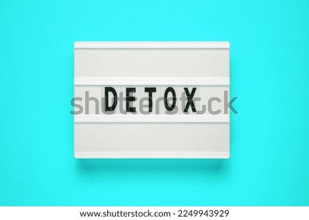 Lightbox with word detox on blue background. Healthcare concept. Digital detox as disconnected internet life style concept.