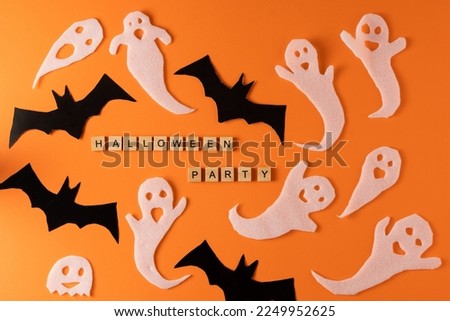 White ghosts and bat craft for Halloween party. Wrapping paper ghost on orange background top view. Cartoon creepy Whisper. DIY hand made. Set boo characters. Word wooden letter phrase.
